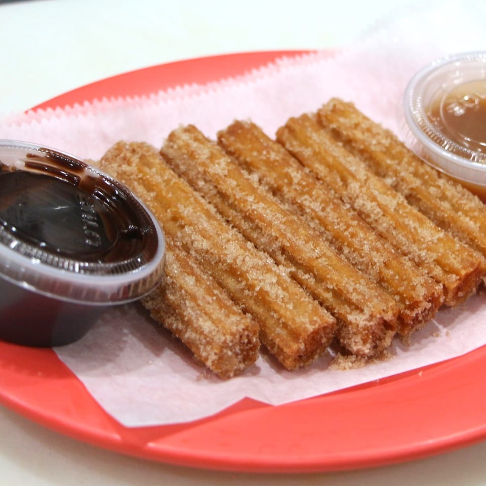 Krave Tacos' churros, coated in cinnamon sugar, served with chocolate and caramel dipping sauces.